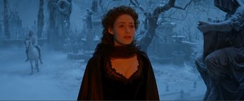 Movie still from “The Phantom of the Opera” (2004), directed by Joel Schumacher – A woman wearing a black dress and a black veil; Medium shot, Over the shoulder angle
