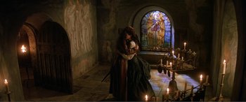 Movie still from “The Phantom of the Opera” (2004), directed by Joel Schumacher – A couple of people that are hugging in a room; Wide shot, High angle