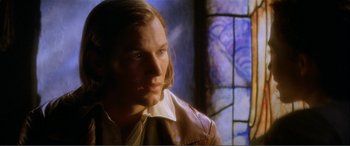 Movie still from “The Phantom of the Opera” (2004), directed by Joel Schumacher – A man with long brown hair wearing a leather jacket; Close Up shot, Over the shoulder angle