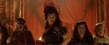 Movie still from “The Phantom of the Opera” (2004), directed by Joel Schumacher – A woman in a black dress and a red hat; Close Up shot, Over the shoulder angle