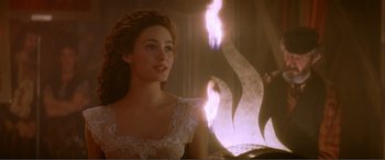 Movie still from “The Phantom of the Opera” (2004), directed by Joel Schumacher – A woman in a white dress is sitting in front of a computer; Close Up shot, Over the shoulder angle