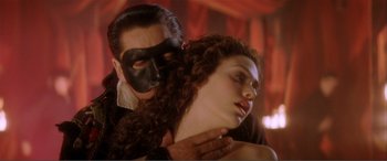 Movie still from “The Phantom of the Opera” (2004), directed by Joel Schumacher – A man and a woman wearing black masks; Close Up shot, Low angle