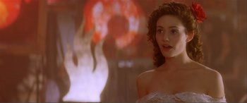 Movie still from “The Phantom of the Opera” (2004), directed by Joel Schumacher – A beautiful young woman in a strapless white dress; Close Up shot, Over the shoulder angle