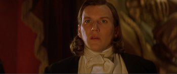 Movie still from “The Phantom of the Opera” (2004), directed by Joel Schumacher – A person wearing a suit and tie; Close Up shot, Low angle