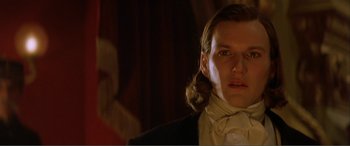 Movie still from “The Phantom of the Opera” (2004), directed by Joel Schumacher – A person wearing a suit and tie; Close Up shot, Low angle