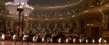 Movie still from “The Phantom of the Opera” (2004), directed by Joel Schumacher – A large group of people sitting in a large theater; Extreme Wide shot, High angle