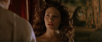 Movie still from “The Phantom of the Opera” (2004), directed by Joel Schumacher – A beautiful woman with long curly brown hair looking at the camera; Close Up shot, Over the shoulder angle