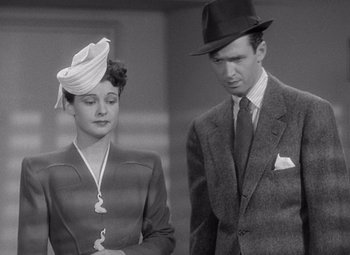 Movie still from “The Philadelphia Story” (1940), directed by George Cukor – A man and a woman standing next to each other; Medium shot, Low angle