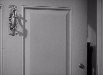 Movie still from “The Philadelphia Story” (1940), directed by George Cukor – A white door in a room with a door knob on the wall; Extreme Close Up shot, High angle