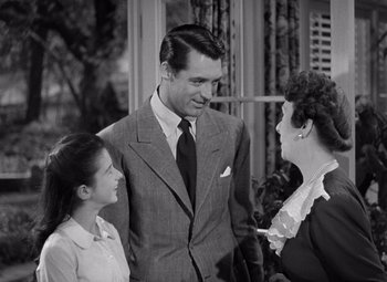 Movie still from “The Philadelphia Story” (1940), directed by George Cukor – A man and two women talking to each other; Medium shot, Over the shoulder angle