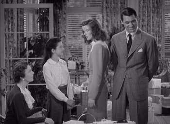 Movie still from “The Philadelphia Story” (1940), directed by George Cukor – A man and a woman standing next to each other; Medium shot, Low angle