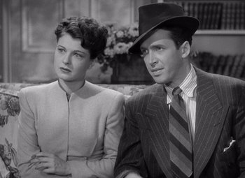 Movie still from “The Philadelphia Story” (1940), directed by George Cukor – A man and a woman sitting next to each other; Close Up shot, High angle