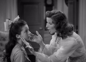 Movie still from “The Philadelphia Story” (1940), directed by George Cukor – An older woman and a young girl are playing with each other; Close Up shot, Over the shoulder angle