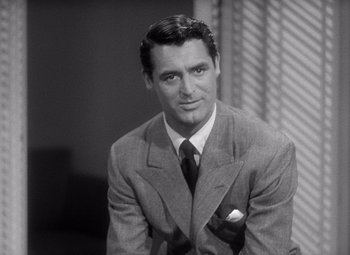 Movie still from “The Philadelphia Story” (1940), directed by George Cukor – A man wearing a suit and tie; Close Up shot, Over the shoulder angle