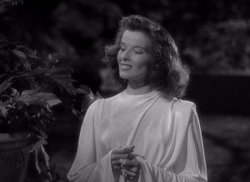 Movie still from “The Philadelphia Story” (1940), directed by George Cukor – A black - and - white photo of a woman holding a cane; Medium shot, Low angle