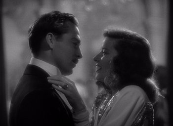 Movie still from “The Philadelphia Story” (1940), directed by George Cukor – A man and a woman standing next to each other; Close Up shot, Low angle