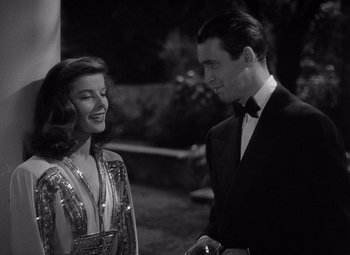 Movie still from “The Philadelphia Story” (1940), directed by George Cukor – A black and white photo of a man and a woman talking; Medium shot, Over the shoulder angle