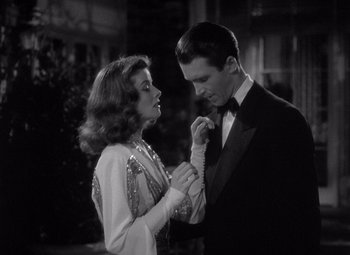 Movie still from “The Philadelphia Story” (1940), directed by George Cukor – A man and a woman in formal wear standing next to each other; Medium shot, Low angle