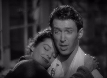 Movie still from “The Philadelphia Story” (1940), directed by George Cukor – A man and a woman embracing each other in a black and white photo; Close Up shot, High angle
