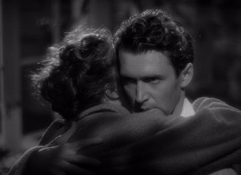 Movie still from “The Philadelphia Story” (1940), directed by George Cukor – A black and white photo of a man and woman hugging; Close Up shot, Over the shoulder angle