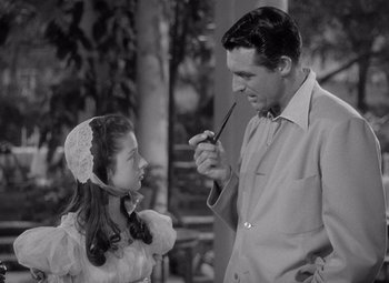 Movie still from “The Philadelphia Story” (1940), directed by George Cukor – A man and a little girl looking at each other; Medium shot, High angle
