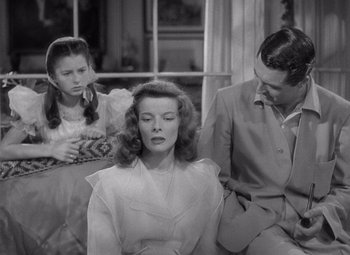 Movie still from “The Philadelphia Story” (1940), directed by George Cukor – A man and a woman sitting next to each other on a bench; Medium shot, High angle