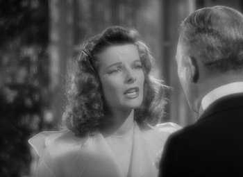 Movie still from “The Philadelphia Story” (1940), directed by George Cukor – An old black and white photo of a man and a woman; Close Up shot, Over the shoulder angle