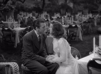 Movie still from “The Philadelphia Story” (1940), directed by George Cukor – A man and a woman sitting in front of each other; Medium shot, High angle