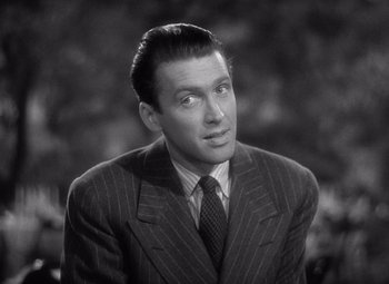 Movie still from “The Philadelphia Story” (1940), directed by George Cukor – A man wearing a suit and tie looking to his left; Close Up shot, High angle