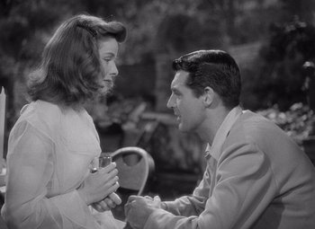 Movie still from “The Philadelphia Story” (1940), directed by George Cukor – A man and a woman sitting on a chair; Medium shot, Over the shoulder angle