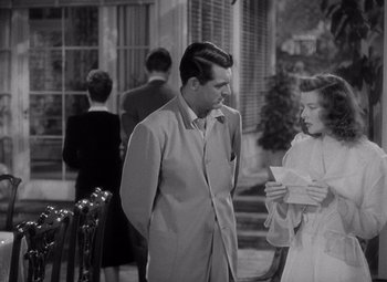 Movie still from “The Philadelphia Story” (1940), directed by George Cukor – A man and a woman standing next to each other; Medium shot, Over the shoulder angle