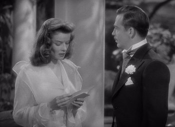 Movie still from “The Philadelphia Story” (1940), directed by George Cukor – A man and a woman looking at each other; Medium shot, Over the shoulder angle