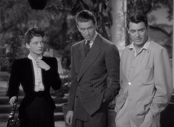 Movie still from “The Philadelphia Story” (1940), directed by George Cukor – A man and two women standing next to each other; Medium shot, Low angle