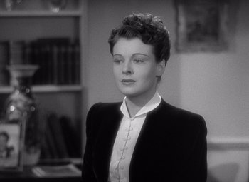 Movie still from “The Philadelphia Story” (1940), directed by George Cukor – A black and white photo of a woman with a cross on her chest; Close Up shot, High angle