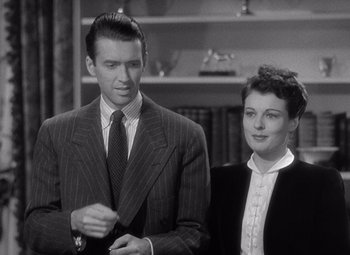 Movie still from “The Philadelphia Story” (1940), directed by George Cukor – A man and a woman standing next to each other; Medium shot, Low angle