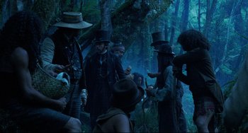Movie still from “The Piano” (1993), directed by Jane Campion – A group of people standing in the forest; Wide shot, Low angle
