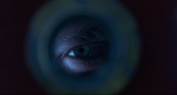 Movie still from “The Piano” (1993), directed by Jane Campion – A person's eye in a dark room; Extreme Close Up shot, Overhead angle