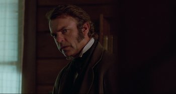 Movie still from “The Piano” (1993), directed by Jane Campion – A person wearing a suit and tie; Close Up shot, Over the shoulder angle