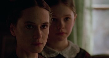 Movie still from “The Piano” (1993), directed by Jane Campion – Two young girls are standing next to each other; Close Up shot, Over the shoulder angle