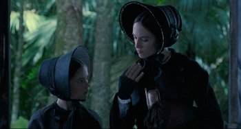 Movie still from “The Piano” (1993), directed by Jane Campion – A woman in a black dress and a woman in a black hat; Close Up shot, Over the shoulder angle
