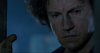 Movie still from “The Piano” (1993), directed by Jane Campion – A man's face in a dark room; Close Up shot, Low angle