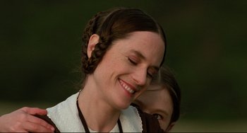 Movie still from “The Piano” (1993), directed by Jane Campion – A woman with braids and a white dress smiling; Close Up shot, Over the shoulder angle
