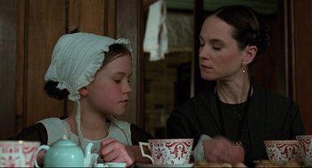 Movie still from “The Piano” (1993), directed by Jane Campion – A woman and a child are sitting at a table; Close Up shot, Over the shoulder angle