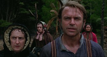 Movie still from “The Piano” (1993), directed by Jane Campion – A man and a woman standing next to each other in the woods; Close Up shot, Low angle