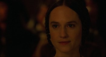 Movie still from “The Piano” (1993), directed by Jane Campion – A woman's face in a dark room; Close Up shot, Over the shoulder angle