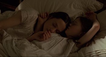 Movie still from “The Piano” (1993), directed by Jane Campion – A woman and a child sleeping in a bed together; Close Up shot, Overhead angle