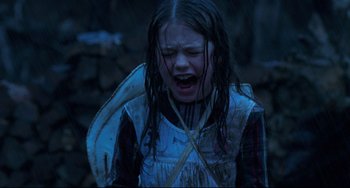 Movie still from “The Piano” (1993), directed by Jane Campion – A young girl is crying while holding a stick; Medium shot, High angle