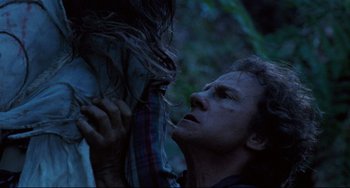 Movie still from “The Piano” (1993), directed by Jane Campion – A man holding a woman up to his chest; Close Up shot, Low angle