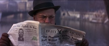 Movie still from “The Pink Panther” (1963), directed by Blake Edwards – A man in a hat and glasses reading a newspaper; Close Up shot, Over the shoulder angle