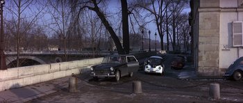 Movie still from “The Pink Panther” (1963), directed by Blake Edwards – Two cars parked in a parking lot next to a tree; Wide shot, High angle